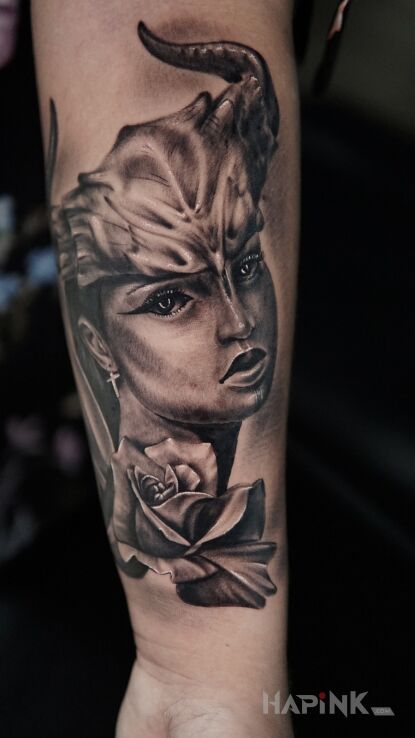 Tattoo Viking girl in flowers motif and realistic style on the forearm
