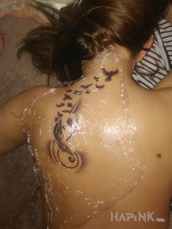 Tattoo Mój pierwszy in animals motif on the shoulder blades