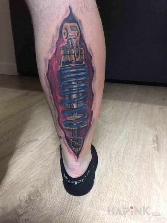 Tattoo Amortyzator in objects motif and biomechanics style on the calf