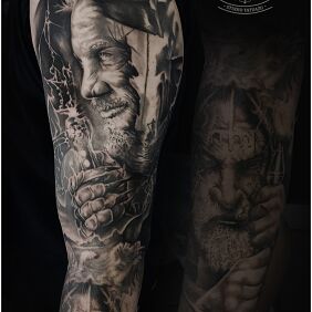 Tattoo Viking on the upper arm motif: black and gray style: realistic
