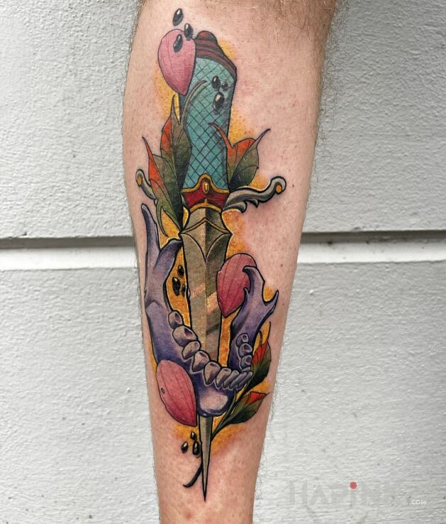 Tattoo Sztylet wbity w kawałek czaszki in colorful motif and neo-traditional style on the forearm