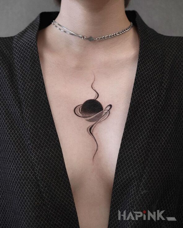 Tattoo Czarna kula in other motif and blackwork / blackout style on the chest