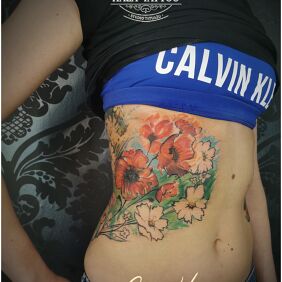 Tattoo Poppy flowers on the ribs motif: flowers style: graphic / illustrative
