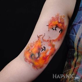 Tattoo Two foxes on the upper arm motif: colorful style: Watercolor
