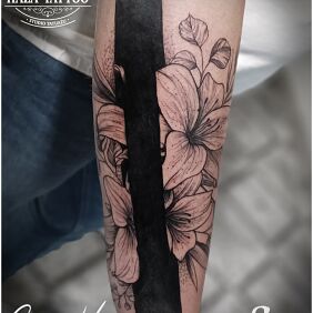 Tattoo Past separated by a black line on the forearm motif: black and gray style: blackwork / blackout