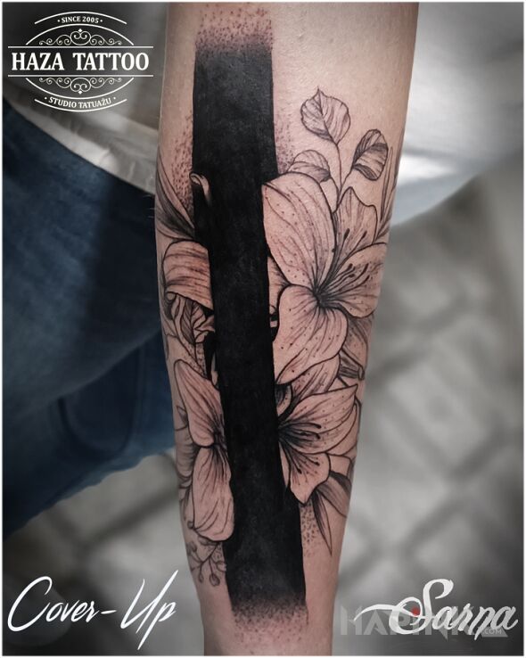 Tattoo Past separated by a black line in black and gray motif and blackwork / blackout style on the forearm