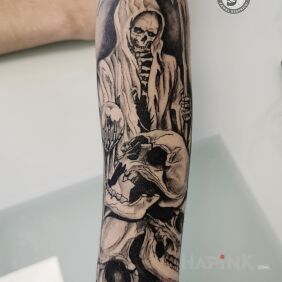 Tattoo Skulls On the arm motif: black and gray style: graphic / illustrative