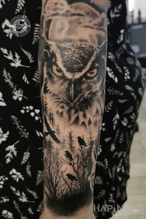 Tattoo Sowa in black and gray motif and realistic style On the arm