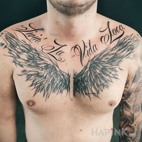 Tattoo Wings on the chest, inscription on the collarbone motif: black and gray style: calligraphy