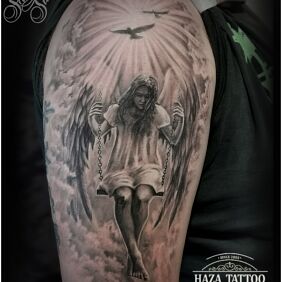 Tattoo Angel on the upper arm motif: black and gray style: realistic