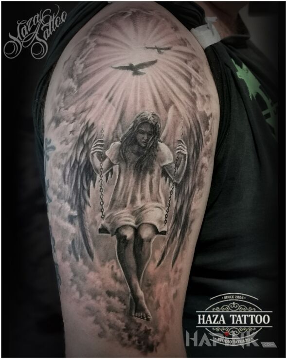 Tattoo Anioł in religious motif and realistic style On the arm