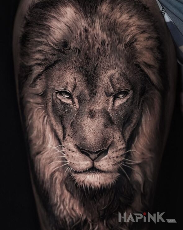 Tattoo Lew królewski in black and gray motif and realistic style on the upper arm