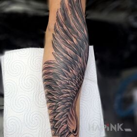 Tattoo Wing on the forearm motif: wings style: graphic / illustrative