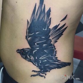 Tattoo Raven on the ribs motif: animals style: blackwork / blackout