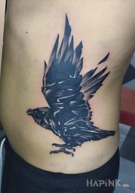Tattoo Kruk in black and gray motif and blackwork / blackout style on the ribs