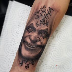 Tattoo Joker On the arm motif: faces style: realistic