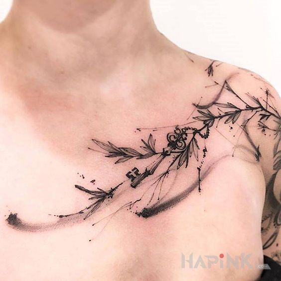 Tattoo Kluczyk in black and gray motif and graphic / illustrative style on the collarbone