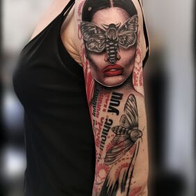 Tattoo Woman with moths on the upper arm motif: lettering style: realistic