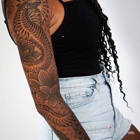 Tattoo Good Cobra On the arm motif: flowers style: graphic / illustrative
