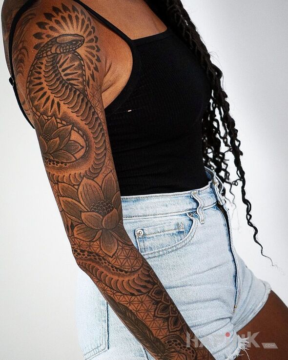 Tattoo Kobra dobra in black and gray motif and graphic / illustrative style on the forearm