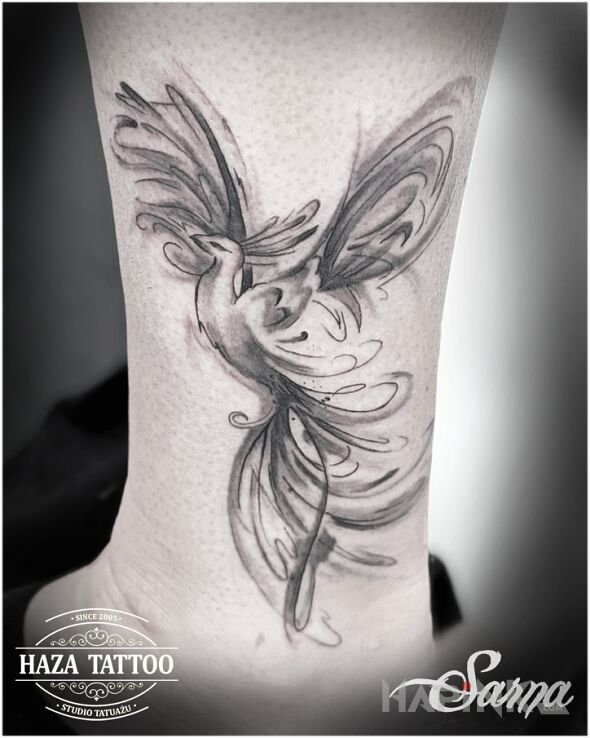Tattoo Phoenix in black and gray motif and graphic / illustrative style on the leg
