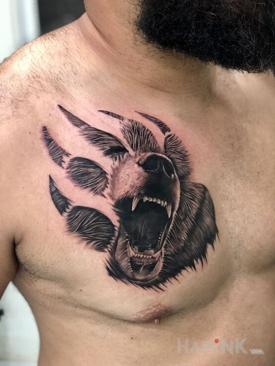 Tattoo Niedźwiedź w łapie in black and gray motif and realistic style on the chest