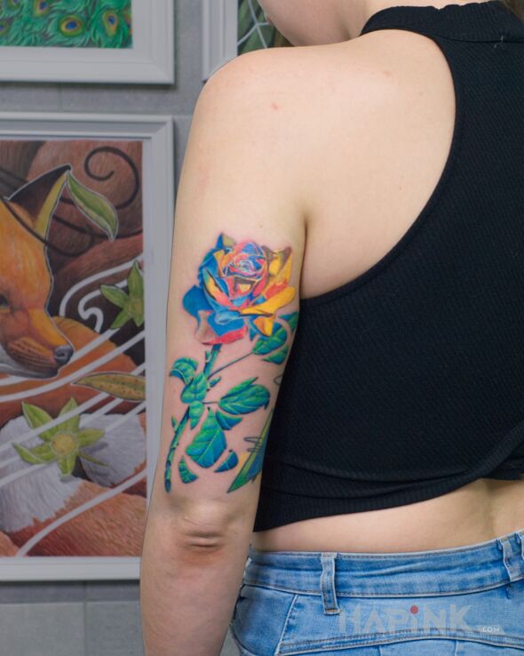 Tattoo Surrealistyczna róża in flowers motif and surrealistic style on the upper arm