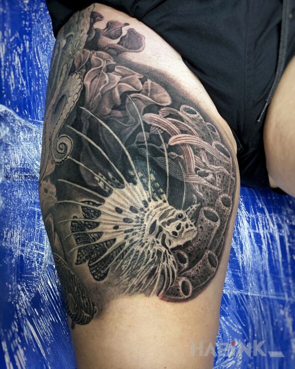 Tattoo Lion Fish in nature motif and realistic style on the leg