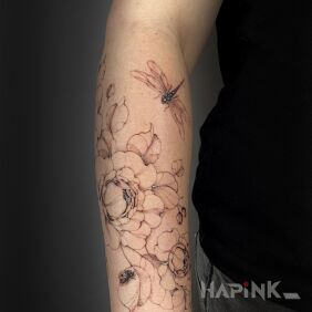 Tattoo Delicate flowers with the addition of a ladybug and dragonfly on the forearm motif: black and gray style: realistic
