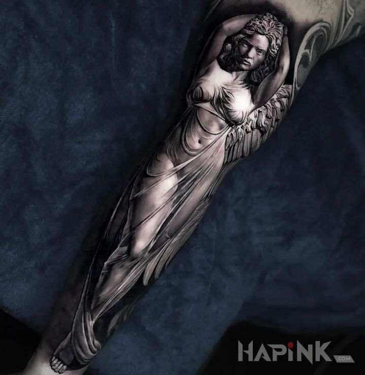 Tattoo Aniele in black and gray motif and realistic style on the forearm