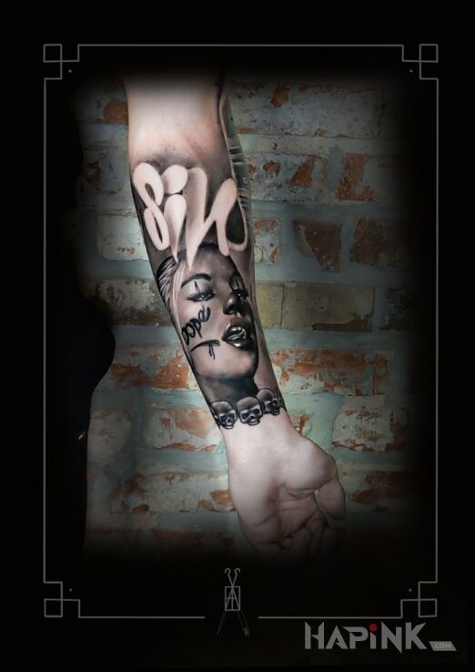 Tattoo Chicano in black and gray motif and chicano style On the arm