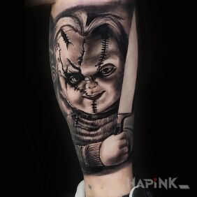Tattoo Chucky on the leg motif: dark style: realistic