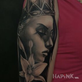 Tattoo Woman with lily on the upper arm motif: black and gray style: realistic