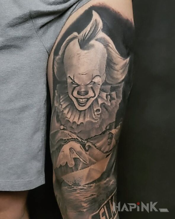 Tattoo Come down in black and gray motif and realistic style on the thigh
