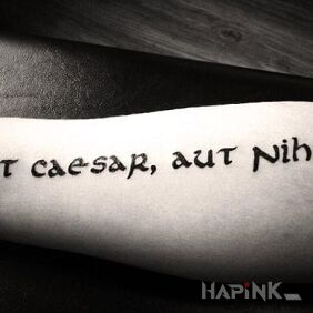 Tattoo Aut caesar, aut nihil on the forearm motif: lettering