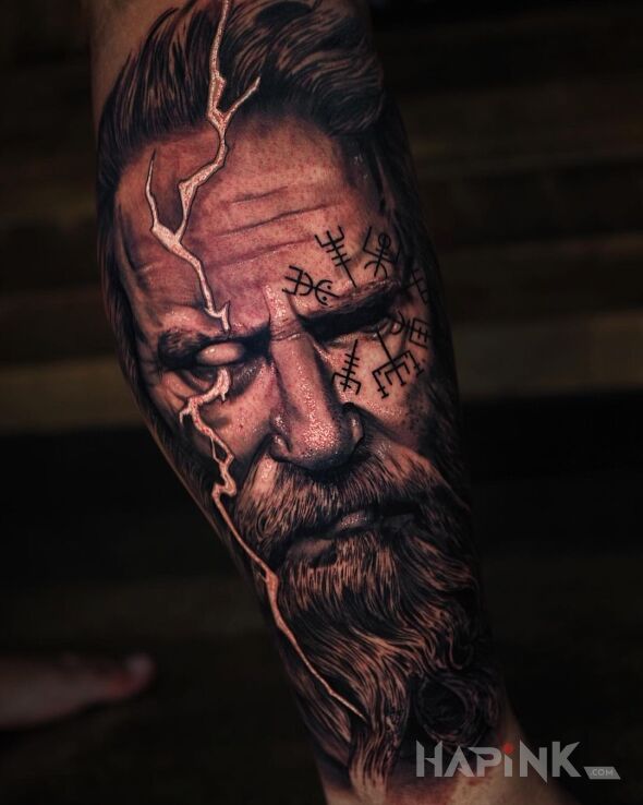 Tattoo Odyn z błyskawicą w oku in faces motif and realistic style on the leg