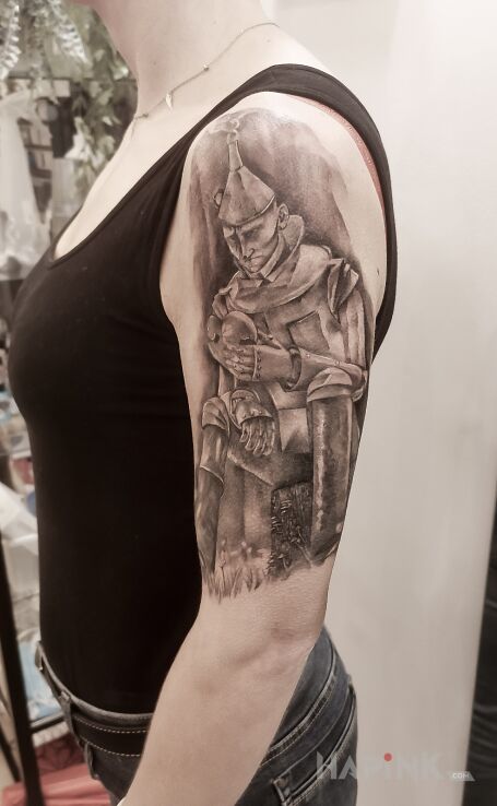 Tattoo Osobisty motyw in characters motif and realistic style on the upper arm