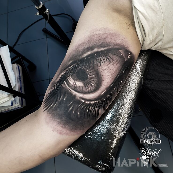 Tattoo Oczy są zwierciadłem duszy :D in black and gray motif and realistic style On the arm