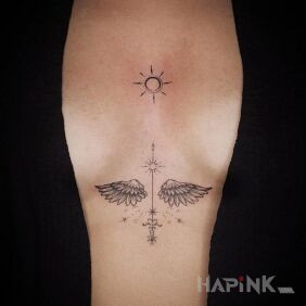 Tattoo Little Wings between the breasts motif: black and gray style: graphic / illustrative
