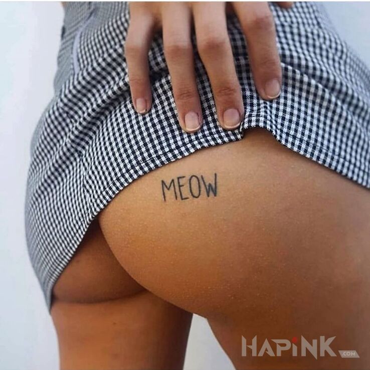 Tattoo Meow in lettering motif and minimalistic style on the buttocks