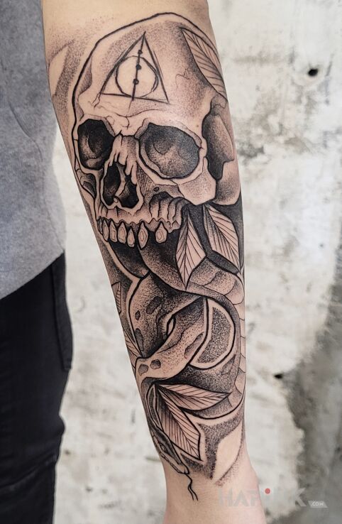 Tattoo Morsmordre in black and gray motif and graphic / illustrative style on the forearm