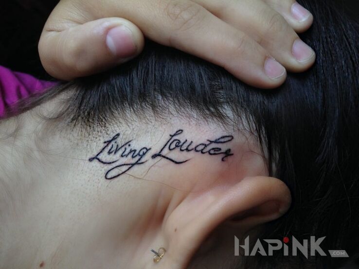 Tattoo Living Louder in lettering motif on the head