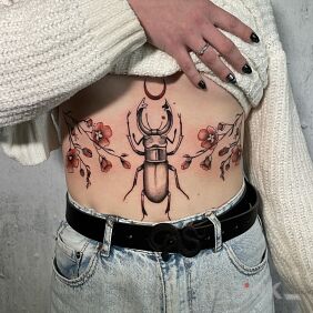 Tattoo Beetle in Flowers on the stomach motif: black and gray style: graphic / illustrative