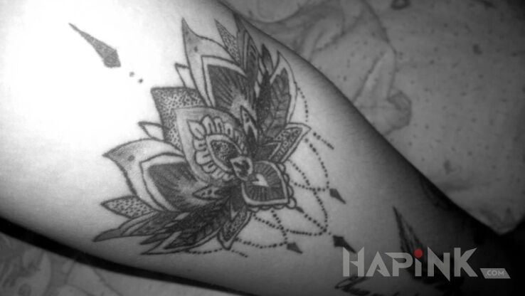 Tattoo Kwiat lotosu in flowers motif on the forearm