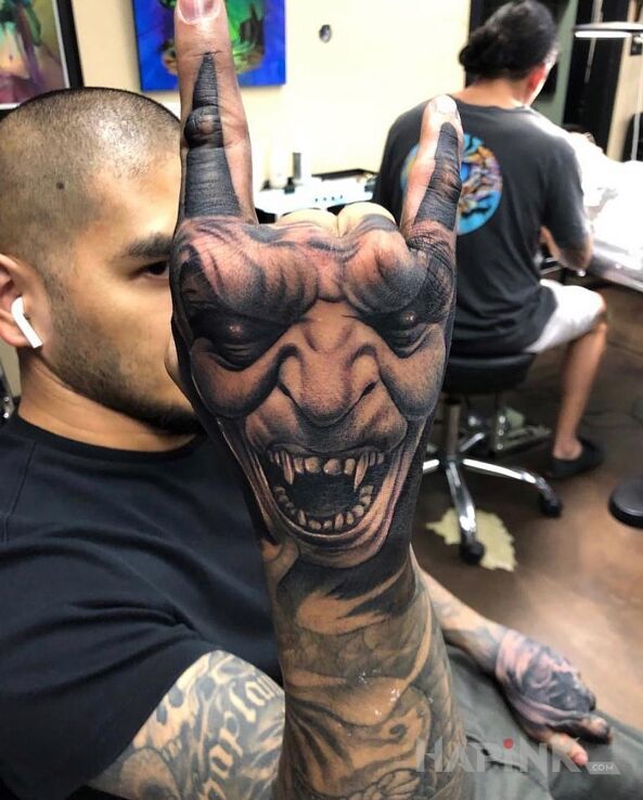 Tattoo Diabeł na łapie in black and gray motif and realistic style On the arm