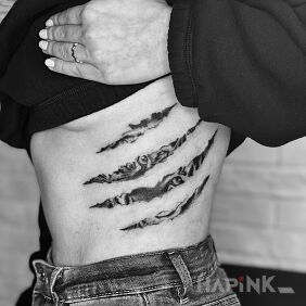 Tattoo Peeking tiger on the ribs motif: animals style: realistic