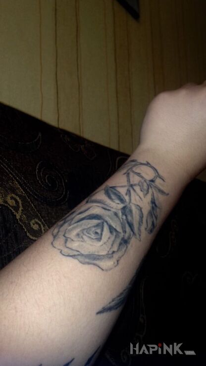 Tattoo Roza in flowers motif on the forearm