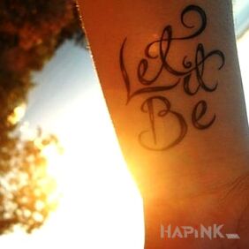 Tattoo Let it be on the forearm motif: lettering
