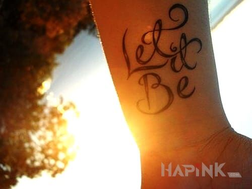 Tattoo Let it be in lettering motif on the forearm