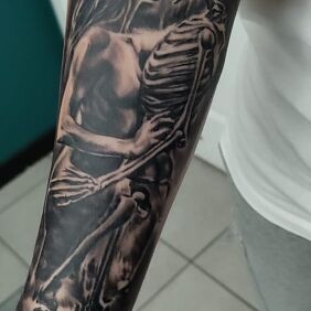 Tattoo Woman and skeleton On the arm motif: characters style: realistic